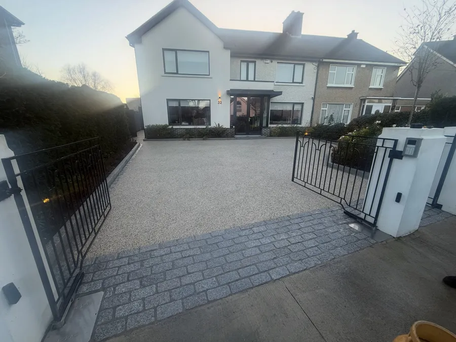 Resin bound drive with a wide granite cobble apron.
